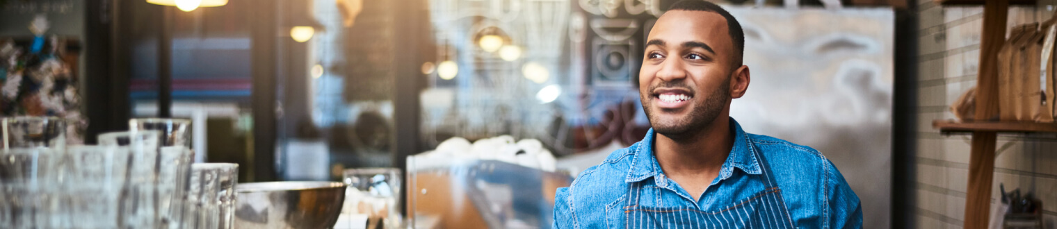 Business owner smiling in his shop.