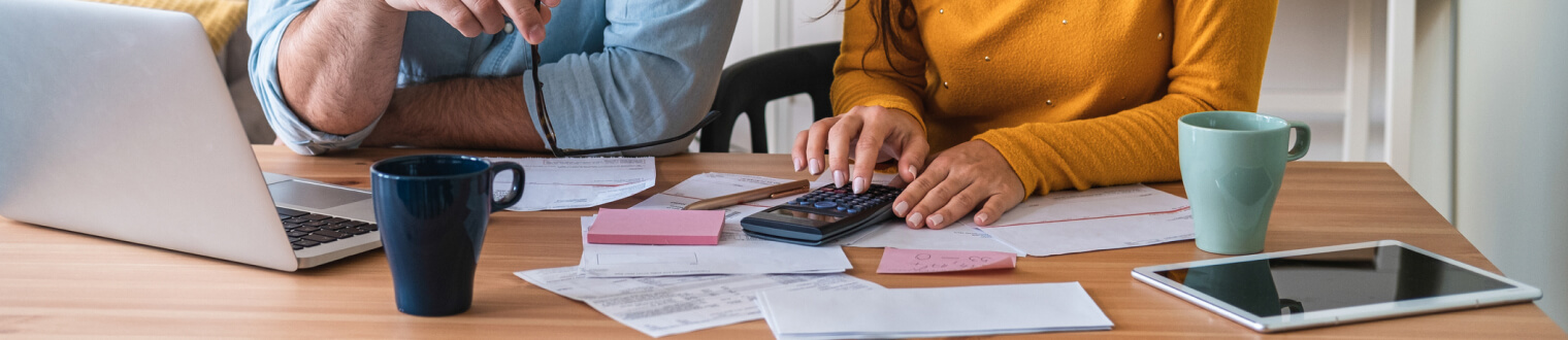 Man and woman sitting a table budgeting 