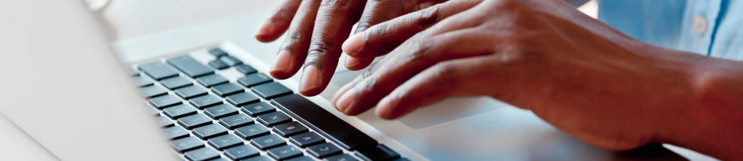 hands typing at laptop